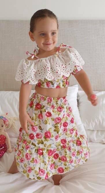 happy little girl in new top and skirt